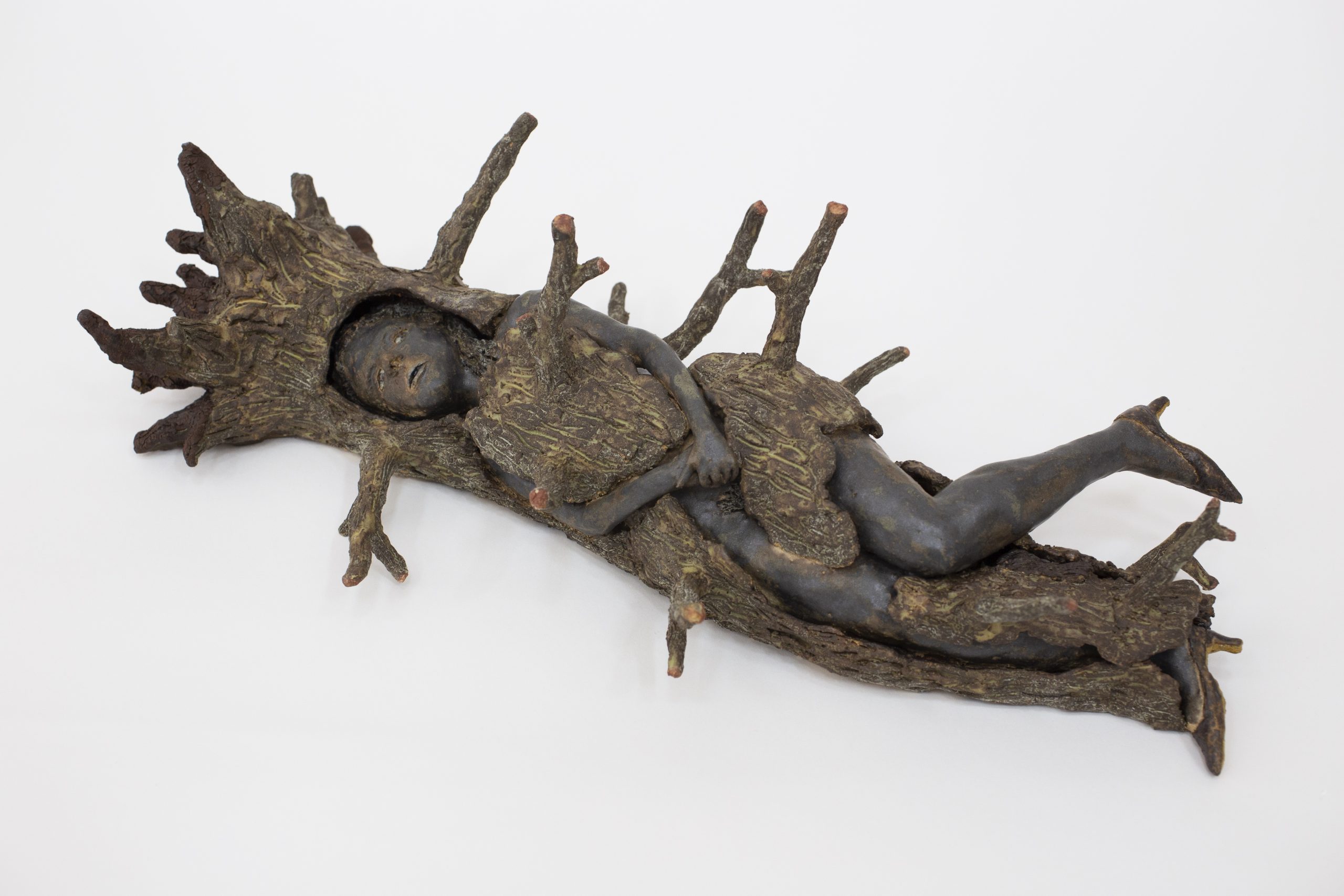 sculpture of tree-woman lying down