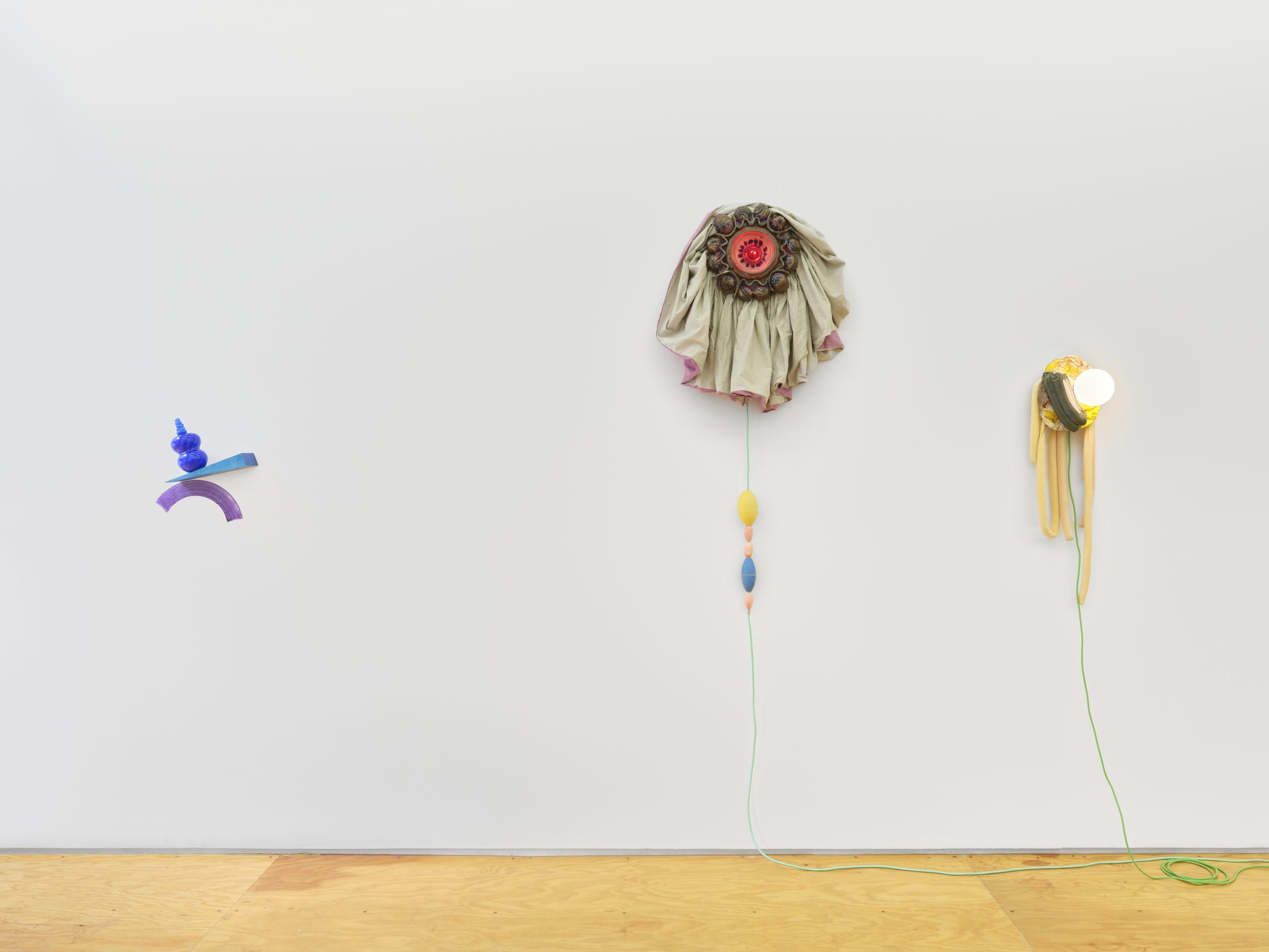 Installation view, Laura Aldridge at Margot Samel. Lamps and sculptures playful colors and range of materials, fabric, glass, wood, ceramic, stone.