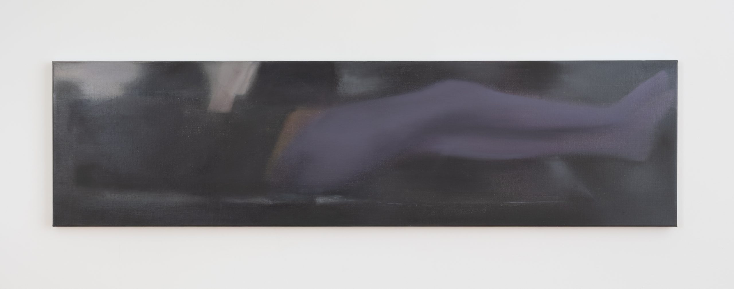 Horizontal dark image of a figure reclining