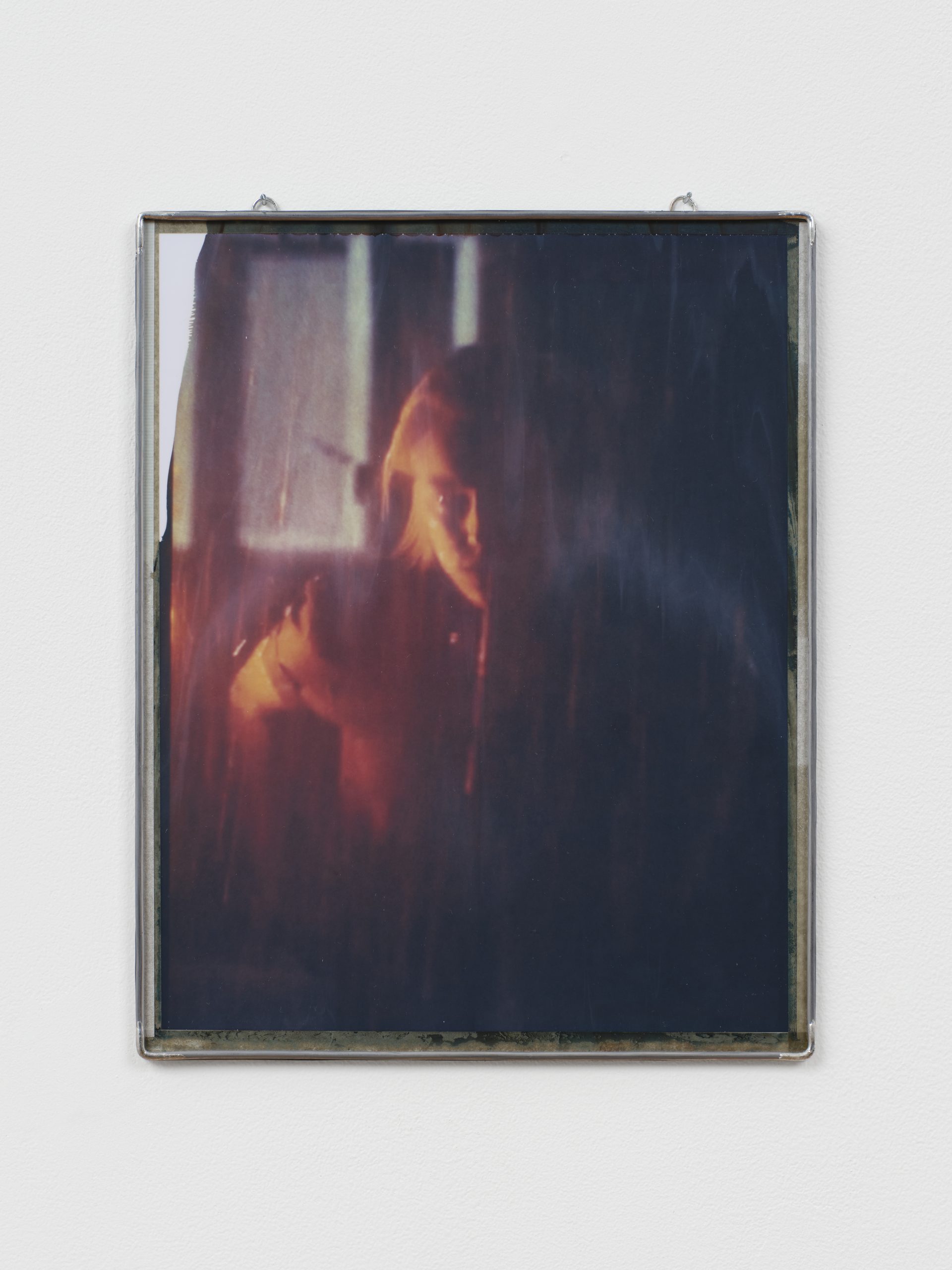 Portrait photograph of a bathing woman, framed in metal