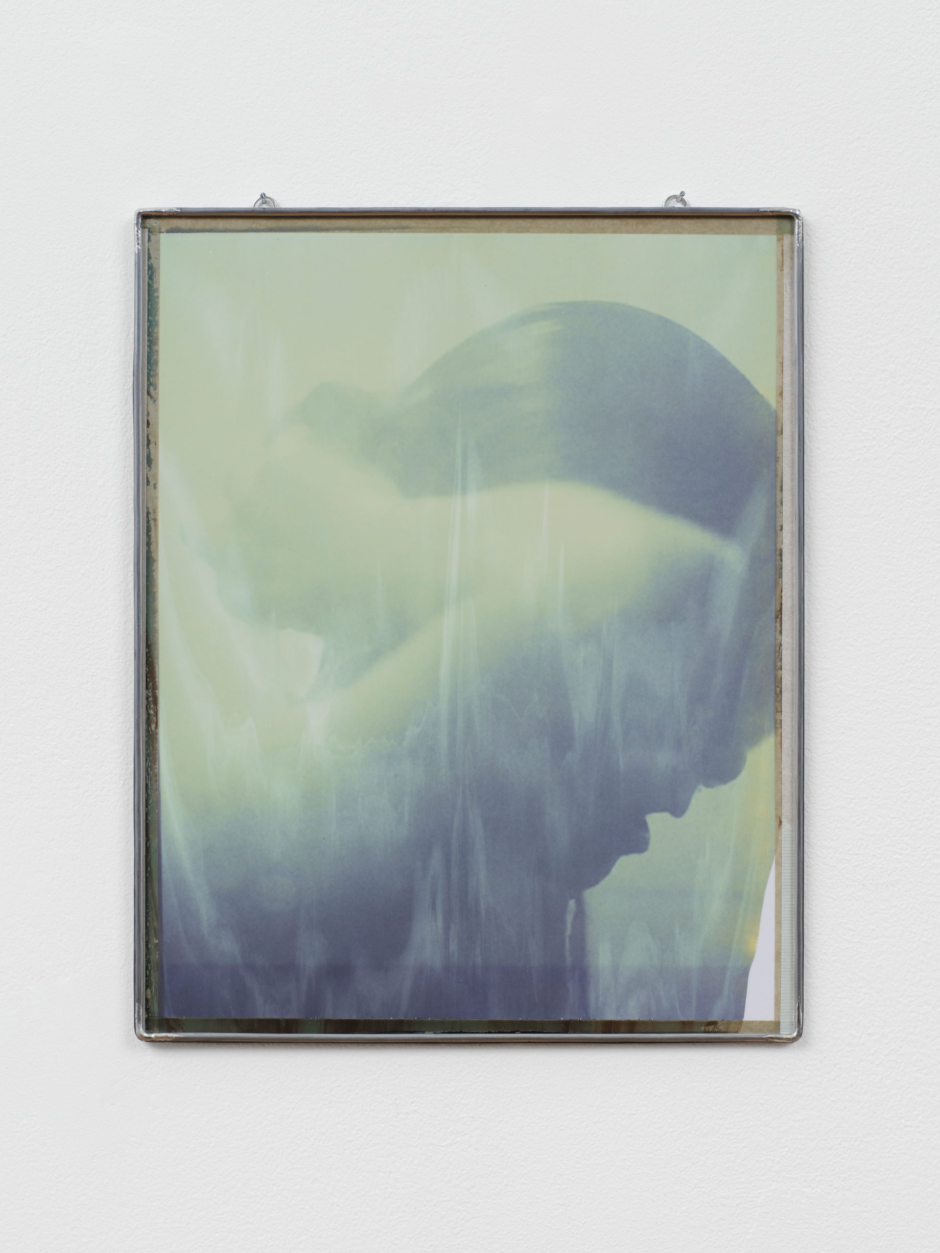 Portrait photograph of a woman in the shower, framed in metal