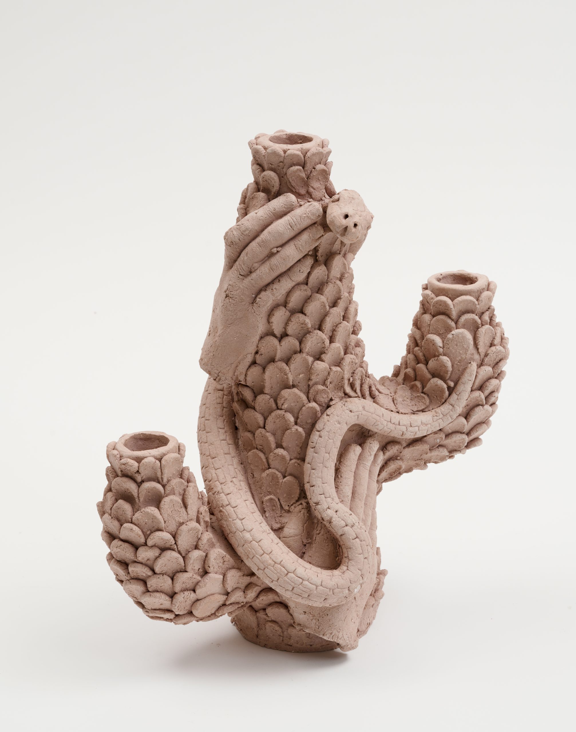 Ceramic candle holder by Edith Karlson. Snake climbing up scaley structure and hands holding onto it.