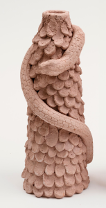 Ceramic candle holder by Edith Karlson. Snake climbing up scales structure.