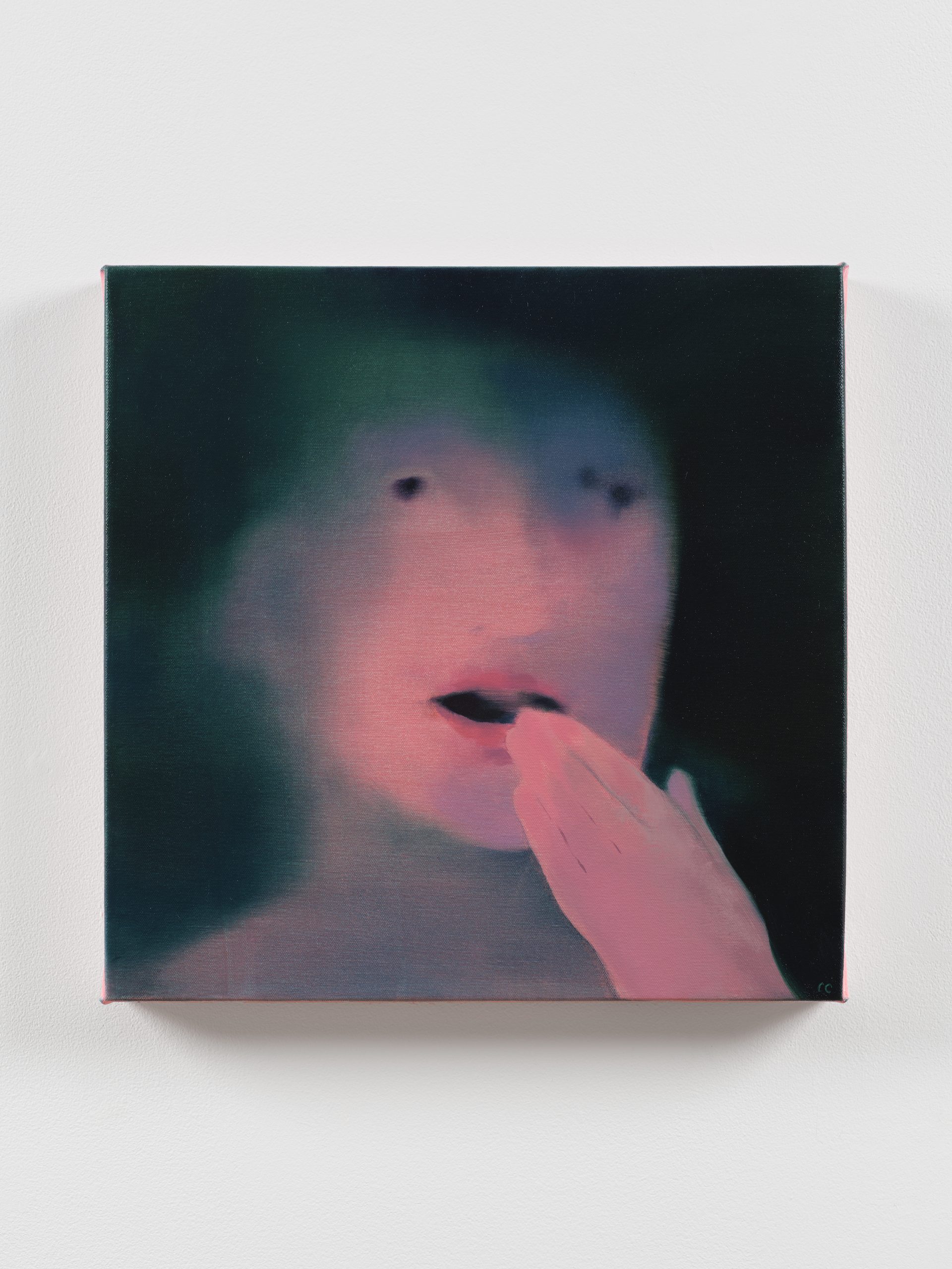 Blurred portrait of a pale face with a pink hand raised to an open mouth in a dark green haze.